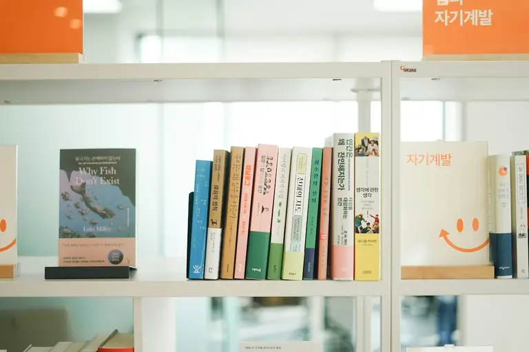 a row of books on a white book shelf