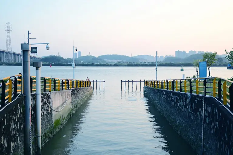 a large body of water next to a pier