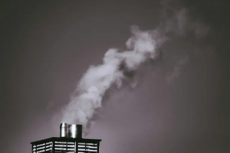 white smoke coming out from a black metal gate