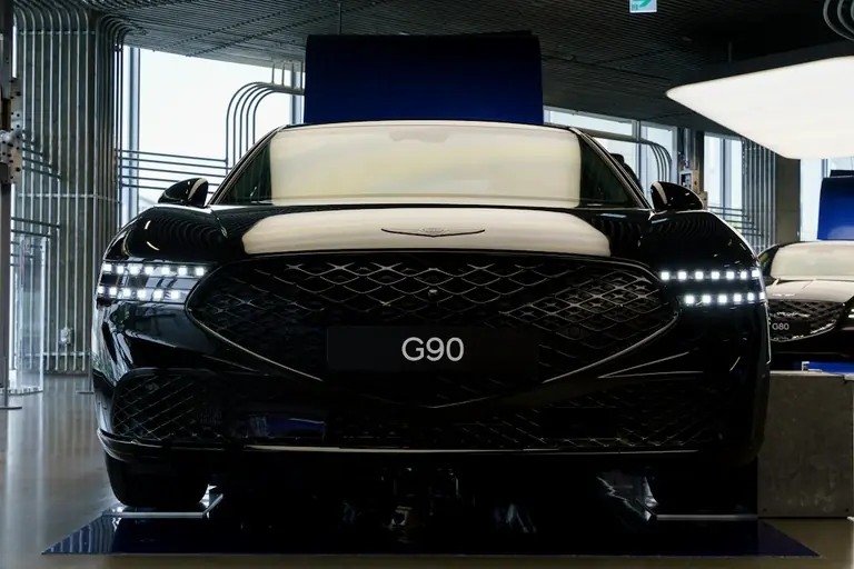 the front of a black car in a garage