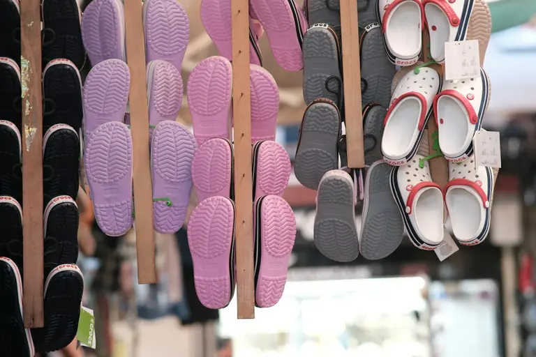 A bunch of shoes that are hanging up