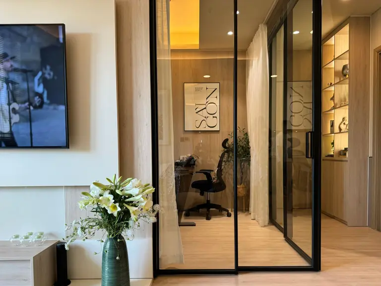 Contemporary apartment with an open office and stylish decor.