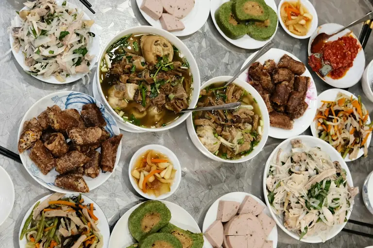 a table topped with lots of plates of food
