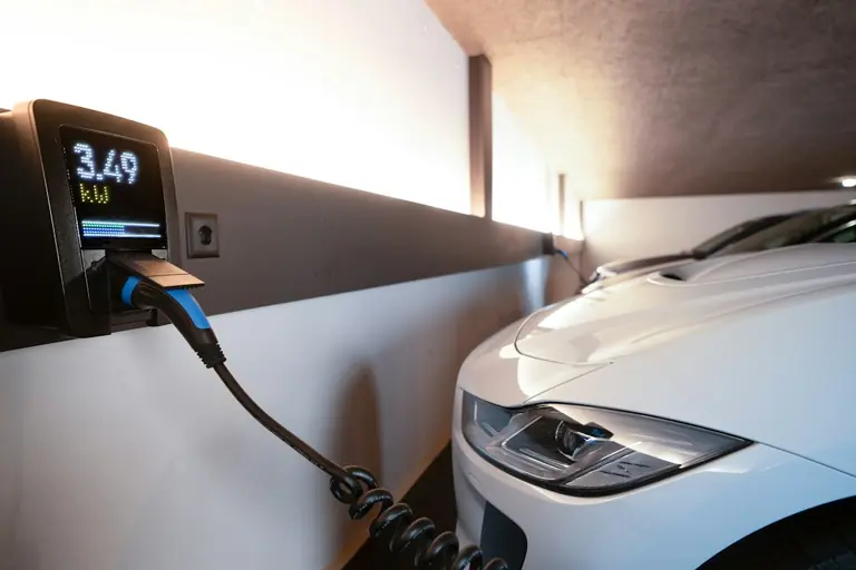 Electric car charging station with a white vehicle