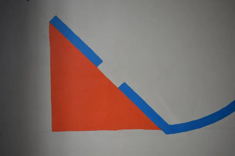 a drawing of a triangle on a white wall
