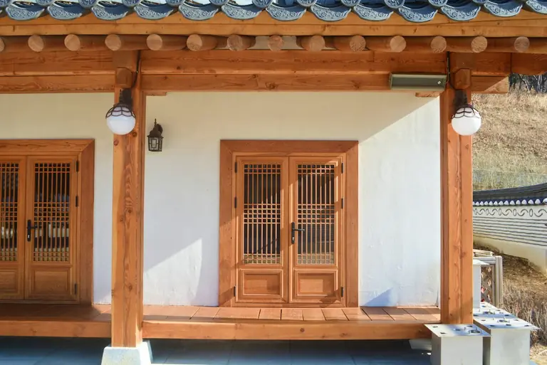 a white building with wooden doors and windows