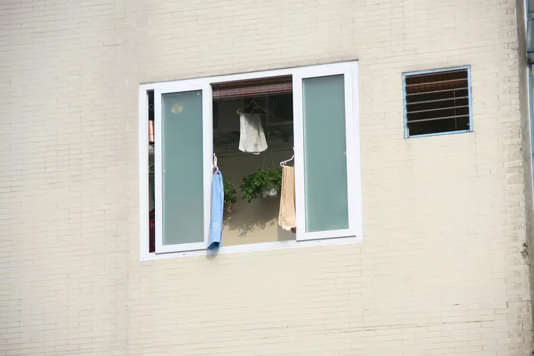 a window with clothes hanging out of it