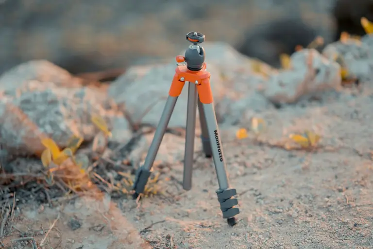 silver and red Monfrotto tripod