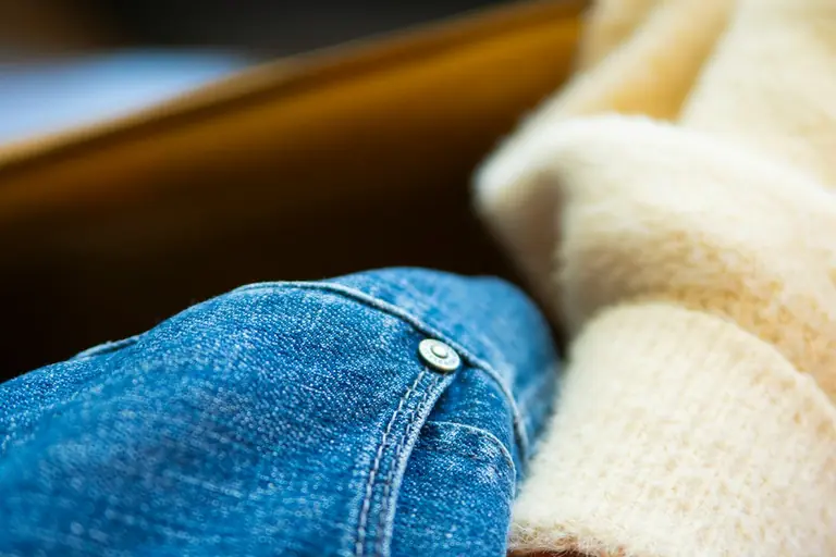a pair of blue jeans laying on top of each other