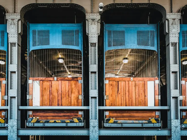 A group of wooden doors sitting inside of a building