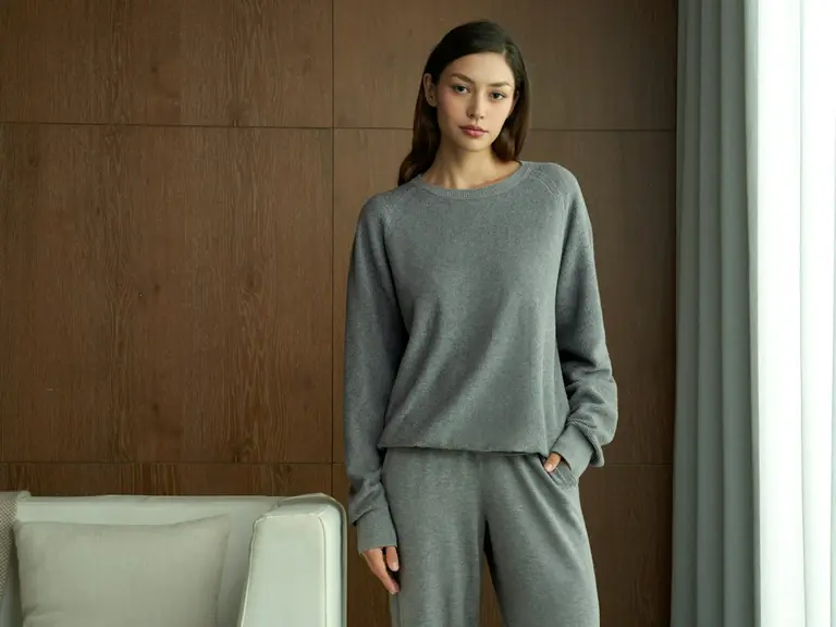 Woman wearing a grey loungewear set indoors.