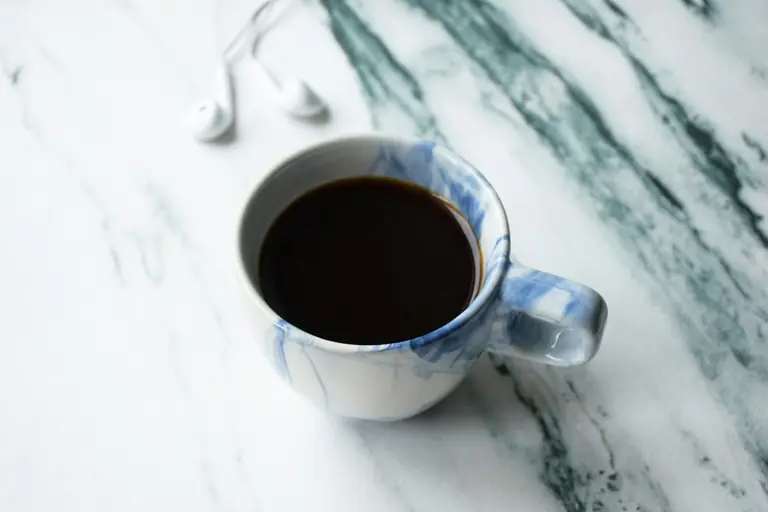 a cup of coffee sitting on top of a table