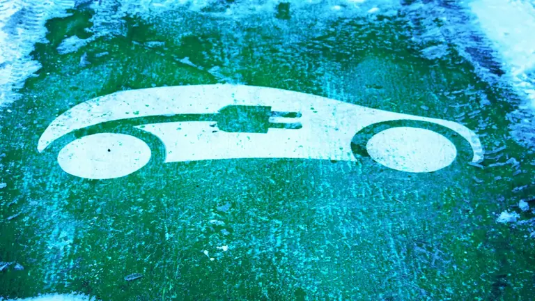 Electric car charging symbol on green ground
