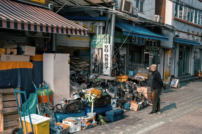 Outdoor shop in Seoul bustling with assorted goods and vibrant street activity.