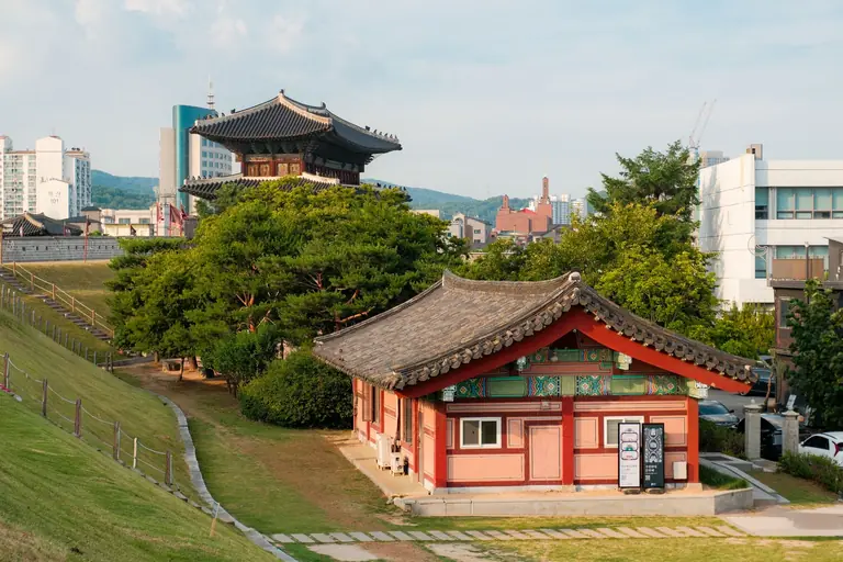 Explore the harmony of traditional Korean architecture with modern cityscape.