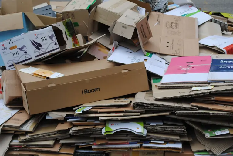 Pile of used cardboard boxes for recycling, ideal for environmental themes.