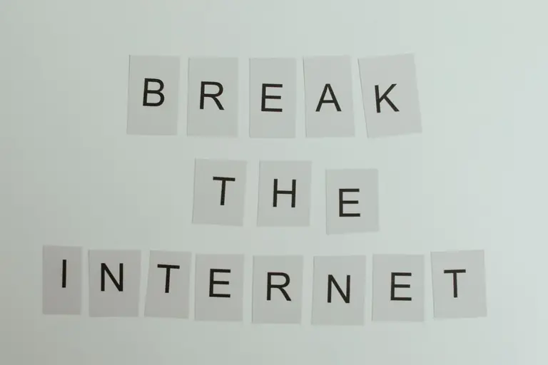 Conceptual image with text 'Break the Internet' using letter cards on a light background.